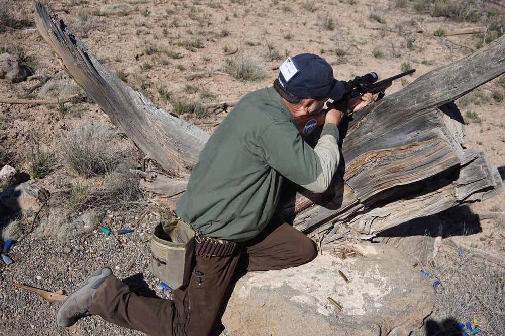 Safari Club Associate Publisher Scott Mayer finds a tree stump to be a good rest as he engages a target on the Gunsite Scrambler course.